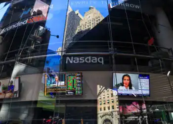 Stock market news displayed on a television at the Nasdaq MarketSite in New York, US, on Tuesday, March 11, 2025. The stock market on Monday shifted towards defensive sectors such as energy, consumer staples, and utility companies, which tend to fare well during recessions, as investors sought shelter from the potential economic storm. Photographer: Michael Nagle/Bloomberg via Getty Images