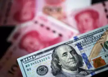 A U.S. one-hundred dollar banknote and Chinese one-hundred yuan banknotes are arranged for a photograph in Hong Kong, China, on Monday, April 15, 2019. China's holdings of Treasury securities rose for a third month as the Asian nation took on more U.S. government debt amid the trade war between the worlds two biggest economies. Photographer: Paul Yeung/Bloomberg via Getty Images
