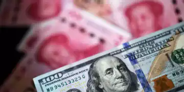A U.S. one-hundred dollar banknote and Chinese one-hundred yuan banknotes are arranged for a photograph in Hong Kong, China, on Monday, April 15, 2019. China's holdings of Treasury securities rose for a third month as the Asian nation took on more U.S. government debt amid the trade war between the worlds two biggest economies. Photographer: Paul Yeung/Bloomberg via Getty Images