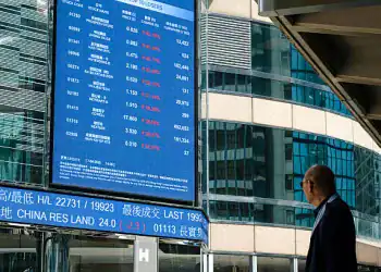HONG KONG, CHINA - APRIL 7:  A man looks at a digital display shows the figures of the stock market on April 7, 2025 in Hong Kong, China. Asian stock markets have plummeted amid growing fears of a global trade war, as Donald Trump described his tariffs as "medicine" and showed no indication of backing down. (Photo by Sawayasu Tsuji/Getty Images)