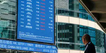 HONG KONG, CHINA - APRIL 7:  A man looks at a digital display shows the figures of the stock market on April 7, 2025 in Hong Kong, China. Asian stock markets have plummeted amid growing fears of a global trade war, as Donald Trump described his tariffs as "medicine" and showed no indication of backing down. (Photo by Sawayasu Tsuji/Getty Images)