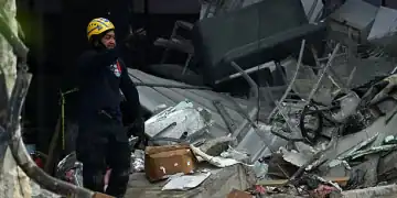 A rescuer stands amid debris at the Jet Set nightclub -which roof collapsed two days ago- in Santo Domingo on April 10, 2025. The death toll in the collapse has reached 218, security forces reported, as they concentrate on finding the last bodies in the area of the tragedy. More than 500 people were injured in the incident. (Photo by MARTIN BERNETTI / AFP) (Photo by MARTIN BERNETTI/AFP via Getty Images)