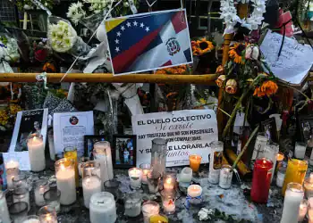 Candles are pictured while friends and relatives pay tribute to the victims in front of the Jet Set nightclub in Santo Domingo on April 12, 2025. The number of deaths caused by the collapse of a discotheque in the Dominican Republic rose to 226, authorities reported on Saturday, as they completed the delivery of the bodies in the early hours of the morning. (Photo by Eddy Vittini / AFP) (Photo by EDDY VITTINI/AFP via Getty Images)