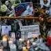 Candles are pictured while friends and relatives pay tribute to the victims in front of the Jet Set nightclub in Santo Domingo on April 12, 2025. The number of deaths caused by the collapse of a discotheque in the Dominican Republic rose to 226, authorities reported on Saturday, as they completed the delivery of the bodies in the early hours of the morning. (Photo by Eddy Vittini / AFP) (Photo by EDDY VITTINI/AFP via Getty Images)