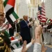 Children wave Emirati and US flags as US President Donald Trump arrives at Qasr Al-Watan (Palace of the Nation) in Abu Dhabi on May 15, 2025. The United Arab Emirates is the third leg of Trump's visit to the region, which has already taken him to Saudi Arabia and Qatar. (Photo by Brendan SMIALOWSKI / AFP)