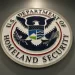 (FILES) The seal of the Department of Homeland Security is seen at US Immigration and Customs Enforcement in Washington, DC, February 25, 2015. When armed immigration agents made a surprise visit earlier this month to Pupatella, a trendy pizzeria in the US capital's Dupont neighborhood, they may not have made any arrests, but they delivered a clear message. The show of force, part of an "enhanced operation" by President Donald Trump's hardline administration, has had ripple effects through an industry reliant on immigrant labor, owners and others in the sector say. The Immigration and Customs Enforcement (ICE) agency said it had arrested 189 undocumented migrants after handing out 187 such notices in the Washington area between May 6 and May 9. (Photo by SAUL LOEB / AFP)