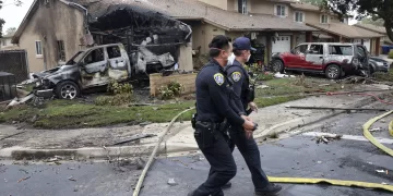 Police officers search the site where a small plane crashed on a San Diego, California, residential street on May 22, 2025. The Federal Aviation Authority said a Cessna 550 crashed at around 3:45 am local time. The neighborhood is close to the Montgomery-Gibbs Executive Airport. The crash left a "gigantic debris field" and damaged some 15 homes and parked cars, ABC News quoted the San Diego assistant fire chief as saying. (Photo by Sandy Huffaker / AFP)