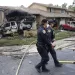 Police officers search the site where a small plane crashed on a San Diego, California, residential street on May 22, 2025. The Federal Aviation Authority said a Cessna 550 crashed at around 3:45 am local time. The neighborhood is close to the Montgomery-Gibbs Executive Airport. The crash left a "gigantic debris field" and damaged some 15 homes and parked cars, ABC News quoted the San Diego assistant fire chief as saying. (Photo by Sandy Huffaker / AFP)