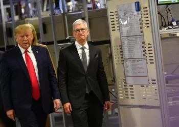 (FILES) US President Donald Trump (L) and Apple CEO Tim Cook tour the Flextronics computer manufacturing facility where Apple's Mac Pros are assembled in Austin, Texas, on November 20, 2019. US President Donald Trump ratcheted up the US trade war on May 23, 2025, threatening to impose a new 25 percent levy against Apple, and a 50 percent tariff on the European Union. The president said Apple had failed to move iPhone production to the United States despite his repeated requests, and he threatened new duties of "at least" 25 percent if they did not comply. (Photo by MANDEL NGAN / AFP)