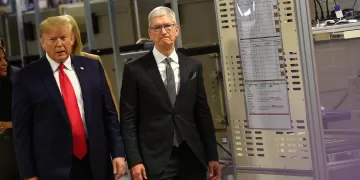 (FILES) US President Donald Trump (L) and Apple CEO Tim Cook tour the Flextronics computer manufacturing facility where Apple's Mac Pros are assembled in Austin, Texas, on November 20, 2019. US President Donald Trump ratcheted up the US trade war on May 23, 2025, threatening to impose a new 25 percent levy against Apple, and a 50 percent tariff on the European Union. The president said Apple had failed to move iPhone production to the United States despite his repeated requests, and he threatened new duties of "at least" 25 percent if they did not comply. (Photo by MANDEL NGAN / AFP)