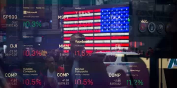 Monitors display stock market information as pedestrians are reflected in a window at the Nasdaq MarketSite in the Times Square area of New York, U.S., on Friday, April 26, 2019. U.S. stocks edged higher on better-than-forecast earnings while Treasury yields fell after data signaled tepid inflation in the first quarter. Photographer: Michael Nagle/Bloomberg via Getty Images