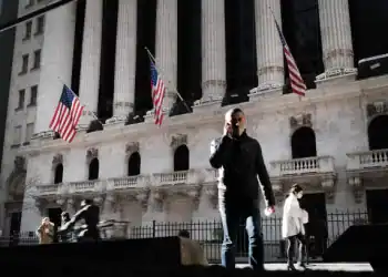 NEW YORK, NEW YORK - NOVEMBER 24: People walk past the New York Stock Exchange (NYSE) on November 24, 2020 in New York City. As investor's fear of an election crisis eases, the DowJones Industrial Average passed the 30,000 milestone for the first time on Tuesday morning.  (Photo by Spencer Platt/Getty Images)