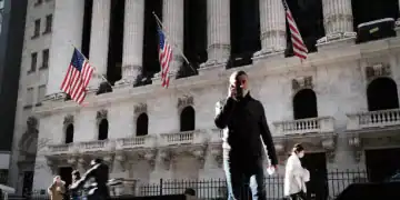 NEW YORK, NEW YORK - NOVEMBER 24: People walk past the New York Stock Exchange (NYSE) on November 24, 2020 in New York City. As investor's fear of an election crisis eases, the DowJones Industrial Average passed the 30,000 milestone for the first time on Tuesday morning.  (Photo by Spencer Platt/Getty Images)