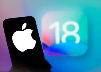 The Apple logo is seen with the iOS 18 operating system logo in the background on a mobile device in this illustration photo taken in Warsaw, Poland on 13 June, 2024. (Photo by Jaap Arriens/NurPhoto via Getty Images)