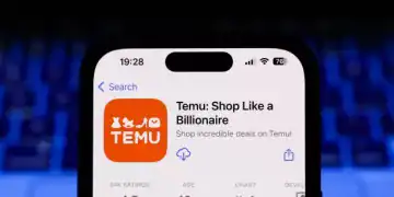 A laptop keyboard and Temu on App Store displayed on a phone screen are seen in this illustration photo taken in Krakow, Poland on March 17, 2025. (Photo by Jakub Porzycki/NurPhoto via Getty Images)