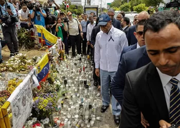 New York Mayor Eric Adams (C) walks in front of the Jet Set night club in Santo Domingo on April 14, 2025. The death toll after the collapse of a discotheque roof in the Dominican Republic rose to 231 with the death of five other injured people who were in hospitals, the government said on April 14, 2025. (Photo by STRINGER / AFP) (Photo by STRINGER/AFP via Getty Images)
