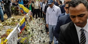 New York Mayor Eric Adams (C) walks in front of the Jet Set night club in Santo Domingo on April 14, 2025. The death toll after the collapse of a discotheque roof in the Dominican Republic rose to 231 with the death of five other injured people who were in hospitals, the government said on April 14, 2025. (Photo by STRINGER / AFP) (Photo by STRINGER/AFP via Getty Images)