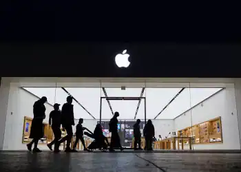 SAN DIEGO, CALIFORNIA - MAY 1: People walk by an Apple store at the Westfield UTC shopping center on May 1, 2025 in San Diego, California. (Photo by Kevin Carter/Getty Images)