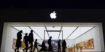 SAN DIEGO, CALIFORNIA - MAY 1: People walk by an Apple store at the Westfield UTC shopping center on May 1, 2025 in San Diego, California. (Photo by Kevin Carter/Getty Images)