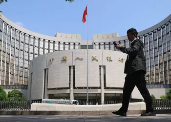BEIJING, CHINA - MAY 07: A citizen walks past the headquarters of the People's Bank of China (PBC), the central bank of China, on May 7, 2025 in Beijing, China. People's Bank of China Governor Pan Gongsheng announced on May 7 that the lending rate to commercial banks would be reduced by 0.25 percentage points to 1.5%. (Photo by Jiang Qiming/China News Service/VCG via Getty Images)