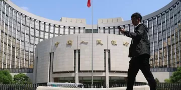 BEIJING, CHINA - MAY 07: A citizen walks past the headquarters of the People's Bank of China (PBC), the central bank of China, on May 7, 2025 in Beijing, China. People's Bank of China Governor Pan Gongsheng announced on May 7 that the lending rate to commercial banks would be reduced by 0.25 percentage points to 1.5%. (Photo by Jiang Qiming/China News Service/VCG via Getty Images)