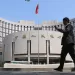 BEIJING, CHINA - MAY 07: A citizen walks past the headquarters of the People's Bank of China (PBC), the central bank of China, on May 7, 2025 in Beijing, China. People's Bank of China Governor Pan Gongsheng announced on May 7 that the lending rate to commercial banks would be reduced by 0.25 percentage points to 1.5%. (Photo by Jiang Qiming/China News Service/VCG via Getty Images)