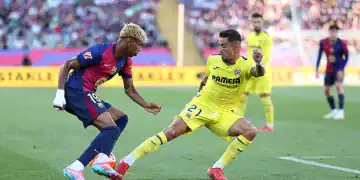 BARCELONA, SPAIN - MAY 18: Lamine Yamal of FC Barcelona is challenged by Yeremy Pino of Villarreal CF during the La Liga EA Sports match between FC Barcelona and Villarreal CF at Estadi Olimpic Lluis Companys on May 18, 2025 in Barcelona, Spain.  (Photo by Judit Cartiel/Getty Images)