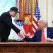 EO Elon Musk shakes hands with U.S. President Donald Trump
