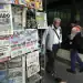 People walk past a newspaper stand the day after the election of judges in Mexico City on June 2, 2025. Mexican President Claudia Sheinbaum hit back Monday at criticism of her country's unprecedented election of judges, after most voters skipped a ballot that her opponents called a farce. (Photo by Alfredo ESTRELLA / AFP)