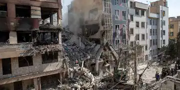 TEHRAN, IRAN - JUNE 13: An excavator removes debris from a residential building that was destroyed in today's attack by Israel in Tehran, on June 13, 2025 in Tehran, Iran. Early this morning, Iran was hit by a series of Israeli airstrikes targeting military and nuclear sites, as well as top military officials. (Photo by Majid Saeedi/Getty Images)