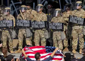 LOS ANGELES, CALIFORNIA - JUNE 09: Protesters confront California National Guard soldiers and police outside of a federal building as protests continue in Los Angeles following three days of clashes with police after a series of immigration raids on June 09, 2025 in Los Angeles, California. Tensions in the city remain high after the Trump administration called in the National Guard against the wishes of city leaders.  (Photo by David McNew/Getty Images)