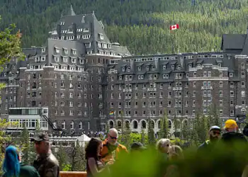 Tourists in front of the Fairmont Banff Springs Hotel ahead of the Group of Seven (G-7) Leaders' Summit, in Banff, Alberta, Canada, on Saturday, June 14, 2025. Group of Seven leaders are heading to a mountain resort in the Canadian Rockies this weekend for their first gathering since Donald Trump returned to the White House. Photographer: Gavin John/Bloomberg via Getty Images
