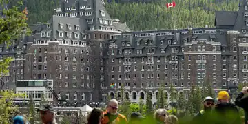 Tourists in front of the Fairmont Banff Springs Hotel ahead of the Group of Seven (G-7) Leaders' Summit, in Banff, Alberta, Canada, on Saturday, June 14, 2025. Group of Seven leaders are heading to a mountain resort in the Canadian Rockies this weekend for their first gathering since Donald Trump returned to the White House. Photographer: Gavin John/Bloomberg via Getty Images