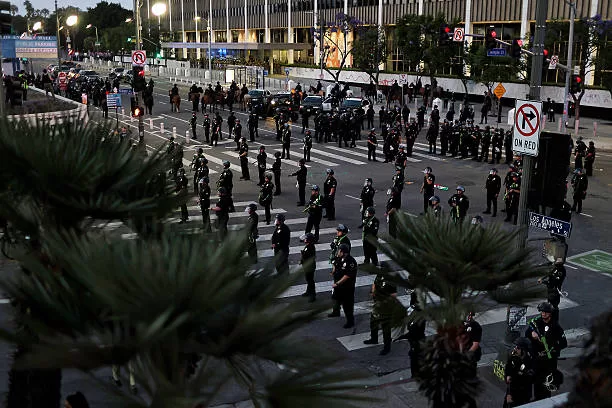 LOS ANGELES, CALIFORNIA - JUNE 10: Police officers mobilize to enforce a curfew after it went into effect during a protest against ICE raids on June 10, 2025 in Los Angeles, California. Tensions in the city remain high after the Trump administration called in the National Guard against the wishes of California Gov. Gavin Newsom and city leaders. Earlier today, Los Angeles Mayor Karen Bass enacted a curfew from 8 p.m. until 6 a.m., saying it was "to stop the vandalism, to stop the looting." (Photo by Jim Vondruska/Getty Images)