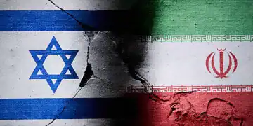 Israeli and Iranian flags are seen in this illustration photo taken in Warsaw, Poland on 16 June, 2025. A missile struck the Islamic Republic of Iran News Network (IRINN) during a live broadcast showing destruction of the studio and the reporter escaping to safety. (Photo by Jaap Arriens/NurPhoto via Getty Images)