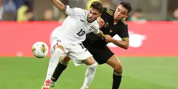 INGLEWOOD, CALIFORNIA - JUNE 14: Edison Azcona #13 of Dominican Republic is marked by Carlos Rodriguez #8 of Mexico during the Group Stage - Group A match between Mexico and Dominican Republic as part of the 2025 CONCACAF Gold Cup at SoFi Stadium on June 14, 2025 in Inglewood, California. (Photo by Omar Vega/Getty Images)