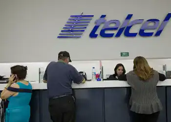 Employees assist customers at an America Movil SAB Telcel service center in Mexico City, Mexico, on Tuesday, July 21, 2015. North America's wireless carriers are in a race to attract customers who make frequent calls and trips between the U.S. and Mexico. America Movil SAB, AT&T Inc., T-Mobile US Inc. and Telefonica Mexico have all introduced plans this year that end cross-border roaming charges and take advantage of a two-country region with more than 400 million people.P hotographer: Susana Gonzalez/Bloomberg via Getty Images