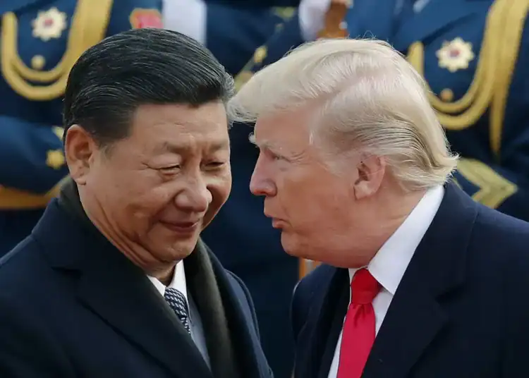 President Trump chats with Chinese President Xi Jinping during a visit to Beijing in 2017. Andy Wong/AP