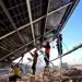ZHANGYE, CHINA - JANUARY 16: Workers install solar panels at the construction site of a 100,000 kilowatt photovoltaic power generation project on January 16, 2024 in Shandan County, Zhangye City, Gansu Province of China. (Photo by VCG/VCG via Getty Images)