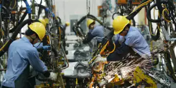 HAIKOU, CHINA - APRIL 6:  (CHINA OUT)  Employees on the assembly line produce cars in Mazda's "Family" line of vehicles at China First Automobile Works (FAW) Group Haima Automobile Co., Ltd. April 6, 2005 in Haikou, Hainan Province, China. China has become the world's third largest automotive market with 2004 car sales in the country growing 15.17 percent to 2.33 million units, even though curbs on credit reduced demand. The market began slowing by mid-2004, affected by the government's measures to cool a fast-expanding economy. Analysts expect car sales in China to increase in 2005 by 10 percent.  (Photo by China Photos/Getty Images)