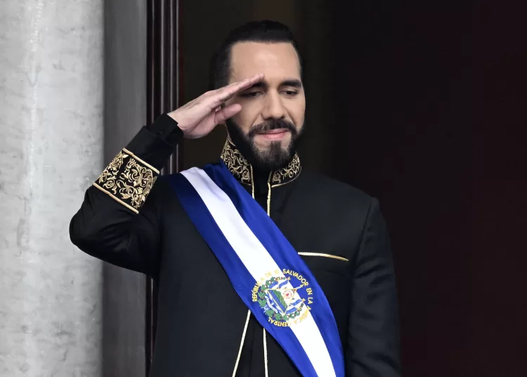 (FILES) El Salvador's President Nayib Bukele salutes during the military parade after being sworn in at the National Palace in downtown San Salvador on June 1, 2024. El Salvador's ruling-party-dominated Congress is discussing indefinite presidential reelection on July 31, 2025, aiming towards President Nayib Bukele's continued presidency. This reform also proposes extending the term of office from five to six years. (Photo by Marvin Recinos / AFP)