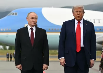 US President Donald Trump (R) and Russian President Vladimir Putin pose on a podium on the tarmac after arrival at Joint Base Elmendorf-Richardson in Anchorage, Alaska, on August 15, 2025. Putin is in Alaska at the invitation of Trump in his first visit to a Western country since he ordered the 2022 invasion of Ukraine that has killed tens of thousands of people. (Photo by ANDREW CABALLERO-REYNOLDS / AFP)