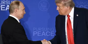 US President Donald Trump (R) and Russian President Vladimir Putin shake hands at the end of a joint press conference after participating in a US-Russia summit on Ukraine at Joint Base Elmendorf-Richardson in Anchorage, Alaska, on August 15, 2025. (Photo by Drew ANGERER / AFP)