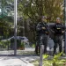 Police officers stand guard outside the REAG Investments building during an operation targeting a money laundering network in Sao Paulo, Brazil, on August 28, 2025. Brazilian police launched a mega operation in several states Thursday to crush a criminal network that sold adulterated fuel to clients and concealed billions of dollars in earnings in cahoots with financial companies. The group allegedly laundered money for the First Capital Command (PCC), one of the country's most powerful gangs engaged in cocaine trafficking from South America to Europe, according to prosecutors. (Photo by Miguel SCHINCARIOL / AFP)