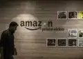 An employee walks past a wall display for Amazon.com Inc.'s Prime Video streaming service at the company's office campus in Hyderabad, India, on Friday, Sept. 6, 2019. Amazon's only company-owned campus outside the U.S. opened at the end of August on the other side of the globe, thousands of miles from their Seattle headquarters. The 15-storey building towers over the landscape in Hyderabad's technology and financial district, signaling the giant online retailer's ambitions to expand in one of the world's fastest-growing retail markets. Photographer: Dhiraj Singh/Bloomberg via Getty Images