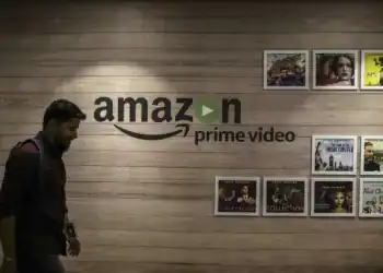 An employee walks past a wall display for Amazon.com Inc.'s Prime Video streaming service at the company's office campus in Hyderabad, India, on Friday, Sept. 6, 2019. Amazon's only company-owned campus outside the U.S. opened at the end of August on the other side of the globe, thousands of miles from their Seattle headquarters. The 15-storey building towers over the landscape in Hyderabad's technology and financial district, signaling the giant online retailer's ambitions to expand in one of the world's fastest-growing retail markets. Photographer: Dhiraj Singh/Bloomberg via Getty Images