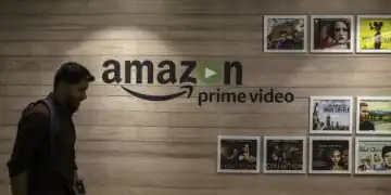 An employee walks past a wall display for Amazon.com Inc.'s Prime Video streaming service at the company's office campus in Hyderabad, India, on Friday, Sept. 6, 2019. Amazon's only company-owned campus outside the U.S. opened at the end of August on the other side of the globe, thousands of miles from their Seattle headquarters. The 15-storey building towers over the landscape in Hyderabad's technology and financial district, signaling the giant online retailer's ambitions to expand in one of the world's fastest-growing retail markets. Photographer: Dhiraj Singh/Bloomberg via Getty Images