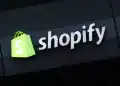 BERLIN, GERMANY - DECEMBER 14: The corporate logo of e-commerce company Shopify hangs at the building that contains the offices of Shopify Commerce Germany GmbH on December 14, 2023 in Berlin, Germany. Shopify is a leading, Canada-based company that enables online and brick-and-mortar commerce. (Photo by Sean Gallup/Getty Images)