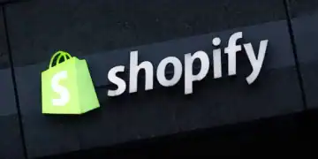 BERLIN, GERMANY - DECEMBER 14: The corporate logo of e-commerce company Shopify hangs at the building that contains the offices of Shopify Commerce Germany GmbH on December 14, 2023 in Berlin, Germany. Shopify is a leading, Canada-based company that enables online and brick-and-mortar commerce. (Photo by Sean Gallup/Getty Images)