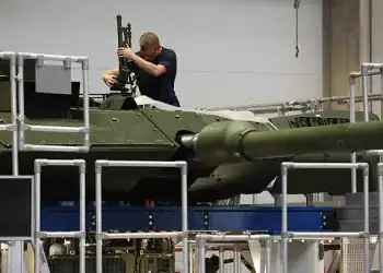 KASSEL, GERMANY - AUGUST 01: A worker installs a machine gun mount onto a Leopard 2A7 main battle tank at the KNDS heavy weapons factory on August 01, 2025 in Kassel, Germany. Germany is investing heavily in the modernization and expansion of the Bundeswehr, its armed forces. (Photo by Sean Gallup/Getty Images)